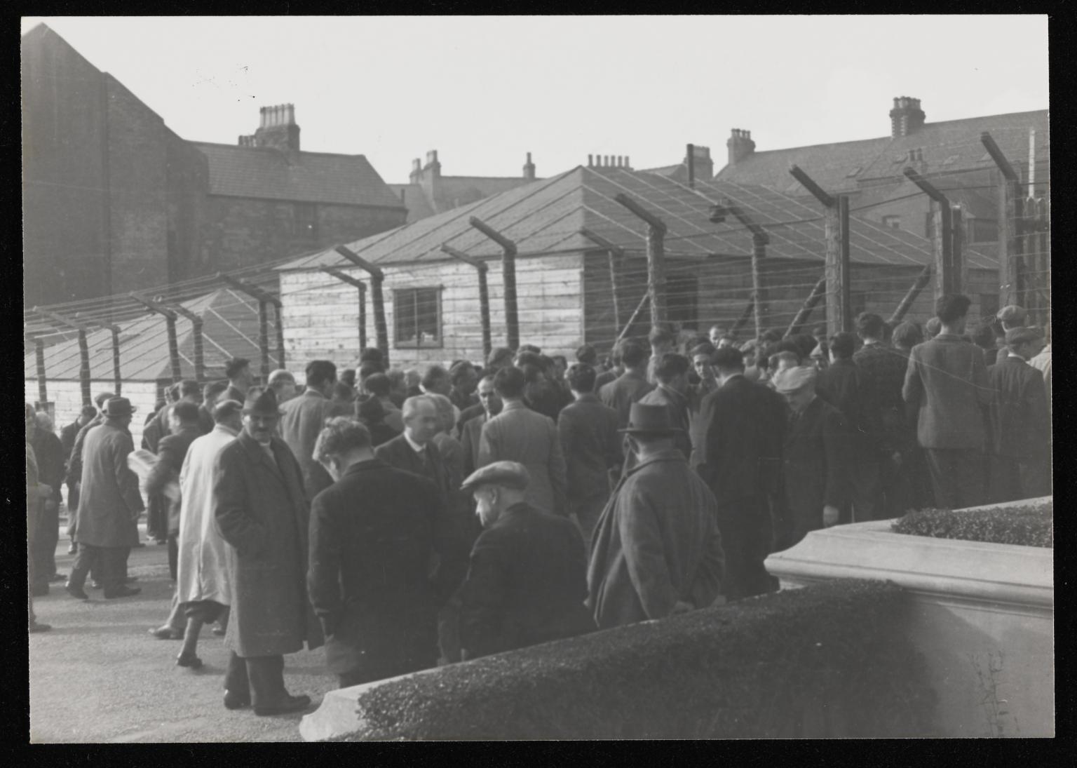 Photograph of internees in a yard at Hutchinson Internment Camp [c.1940-1] by Major H. O. Daniels